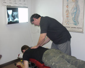Dr. John Harris of Concordville Chiropractic adjusting a patient.